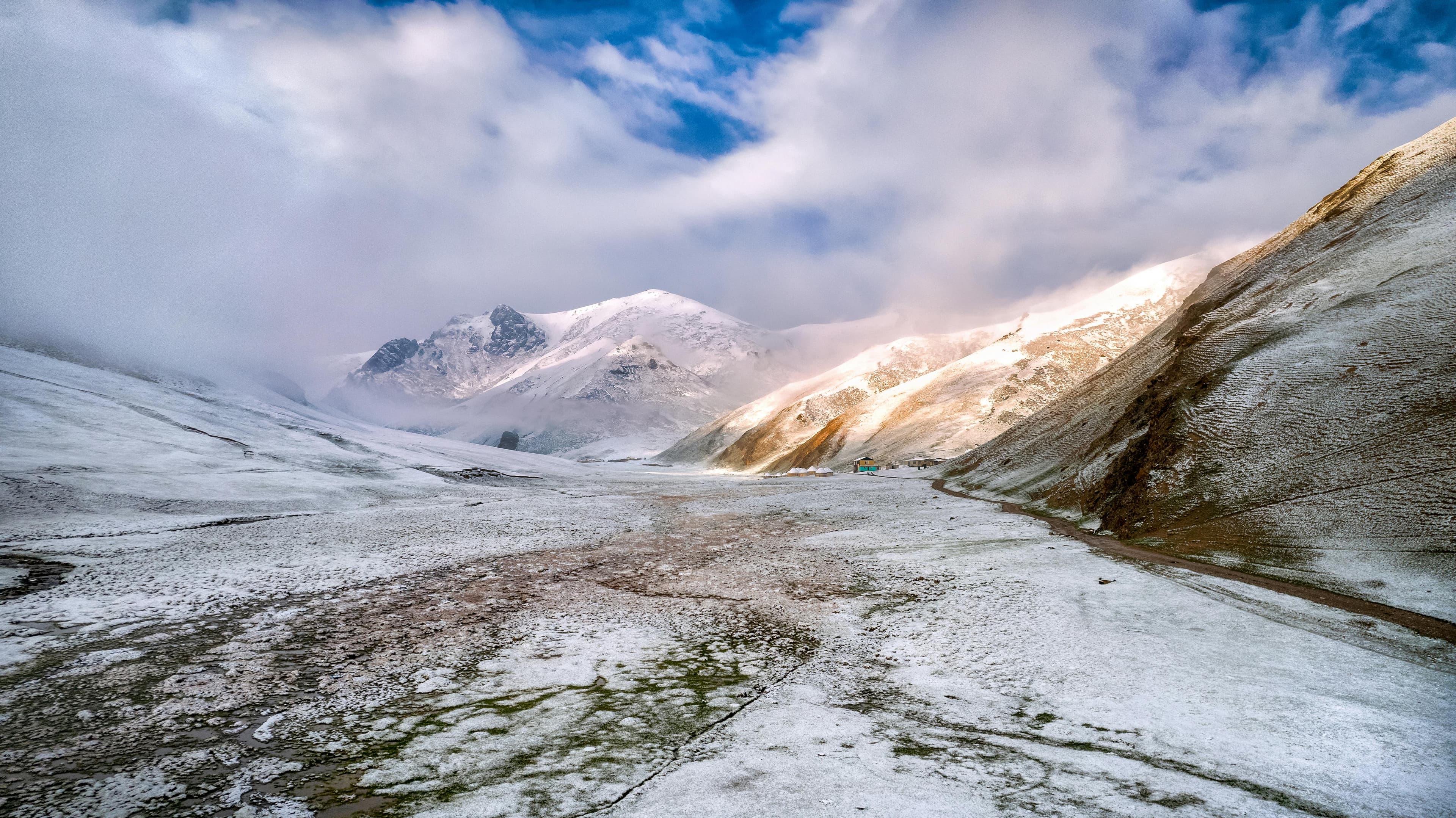 Breathtaking view of snow-covered mountains and a clear sky in Kyrgyzstan