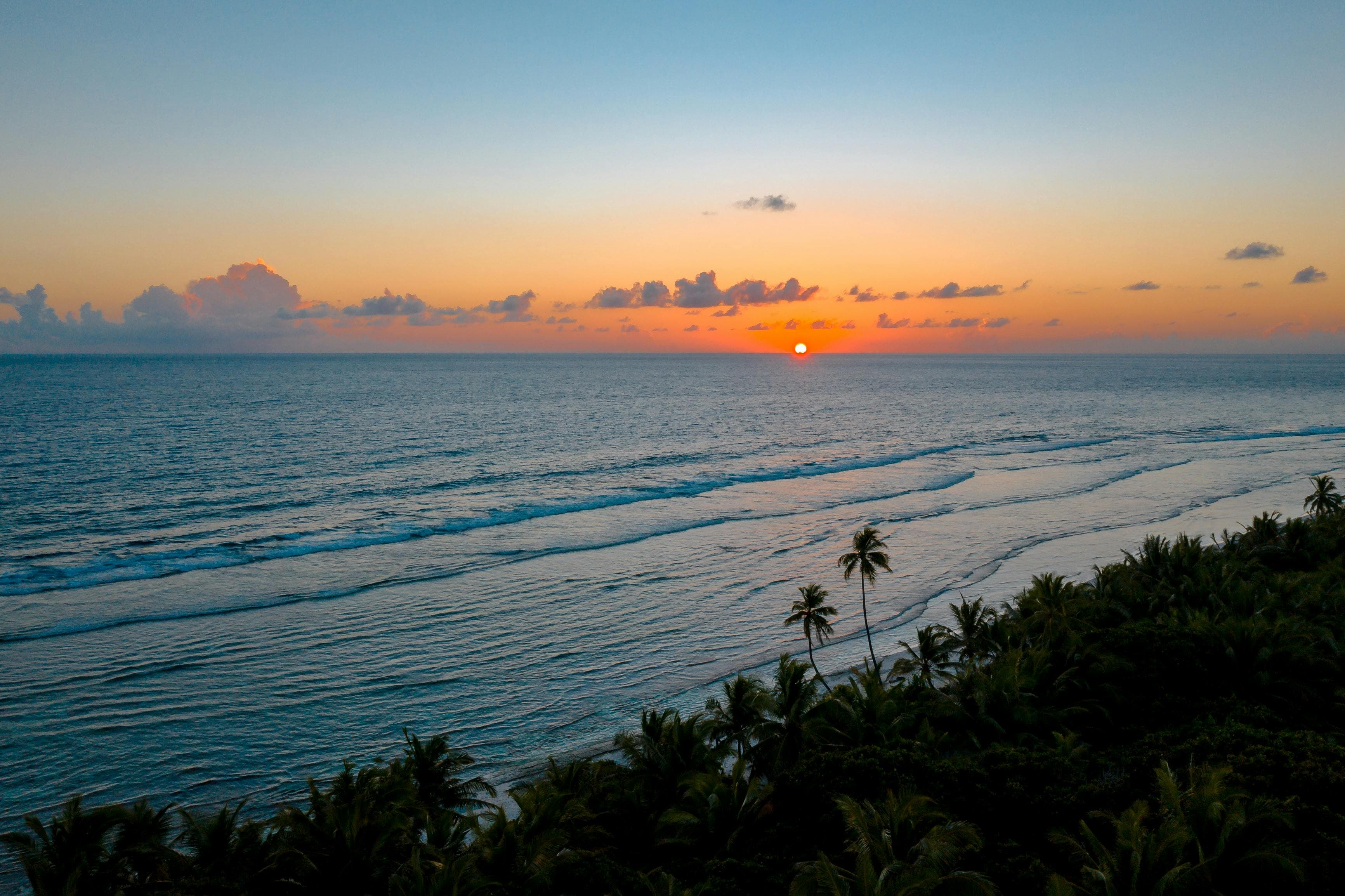 Breathtaking sunset view over tropical beach, showcasing vibrant skies and serene ocean